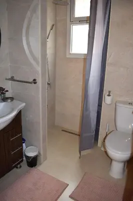 a bathroom with a shower and a toilet and a sink at Chic & Calm in Marrakech, Ideal for Digital Nomads in Marrakech