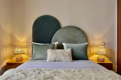 a bedroom with a large bed with two lamps at Apartment in Agdal with Pool and Terrace in Marrakech