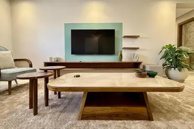 a living room with a coffee table and a tv at Apartment in Agdal with Pool and Terrace in Marrakech
