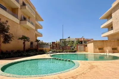 a swimming pool in front of a building at Apartment in Agdal with Pool and Terrace in Marrakech