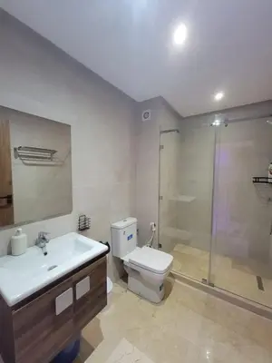 a bathroom with a sink and a toilet and a shower at Élégante Appartement au centre de Marrakech , Piscine - Parking gratuit in Marrakech