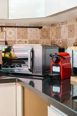 a microwave oven sitting on a counter in a kitchen at Un Appartement d'exception in Marrakech
