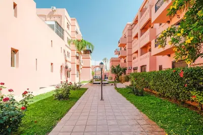 a walkway between two apartment buildings at Un Appartement d'exception in Marrakech