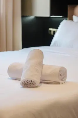 a pair of rolled towels on a bed at Un Appartement d'exception in Marrakech