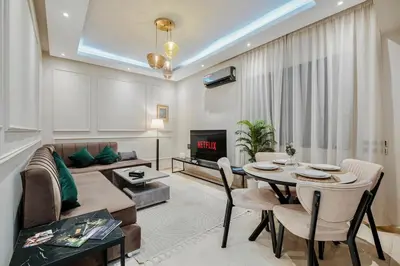 a living room with a table and a couch at Un Appartement d'exception in Marrakech
