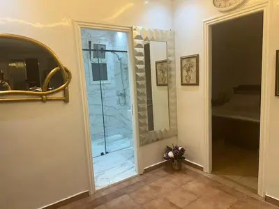 a bathroom with a glass door and a mirror at Cozy Stay Central Marrakech in Marrakech