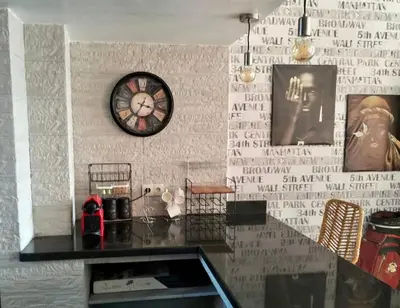 a clock on a wall with writing on it at Pavillon Luxe - Jardin de l'Atlas - Golf & Waky in Sraghna