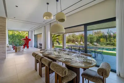 a dining room with a long table and chairs at Villa Simone in Marrakech
