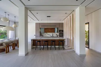 an open kitchen and dining room with a bar with stools at Villa Simone in Marrakech