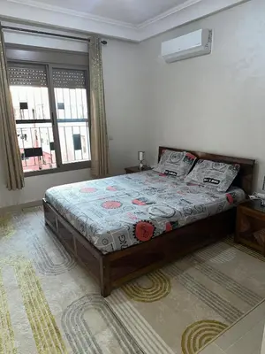 a bedroom with a bed in a room with a window at New and nice apartment in Marrakech