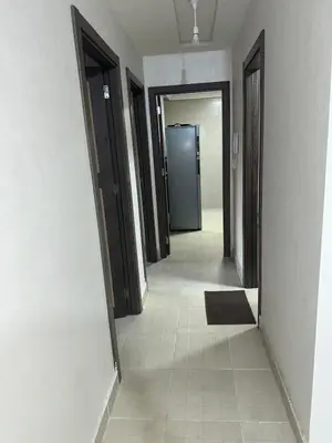 an empty hallway with doors and a tile floor at New and nice apartment in Marrakech