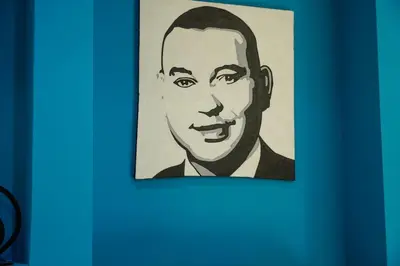 a drawing of a mans face on a blue wall at Modern 2 bedroom apartment, one with terrace in Marrakech