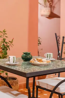 a table with a plate of food on it at Riad Dar Z'r in Marrakech
