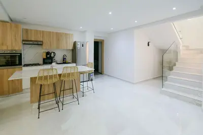 a kitchen with a counter and some stools at Duplex d'exception - 6 personnes - tout équipé in Marrakech