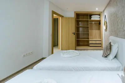a bedroom with two beds and a closet at Duplex d'exception - 6 personnes - tout équipé in Marrakech
