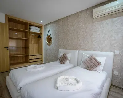 a bedroom with two beds with white sheets at Duplex d'exception - 6 personnes - tout équipé in Marrakech