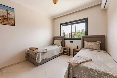 a bedroom with two beds and a window at Rent Appartment In Marrakesh - Morocco - Semlalia in Marrakech