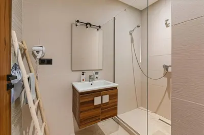 a bathroom with a sink and a shower with a mirror at Rent Appartment In Marrakesh - Morocco - Semlalia in Marrakech