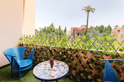 a patio with two chairs and a table and a fence at Rent Appartment In Marrakesh - Morocco - Semlalia in Marrakech