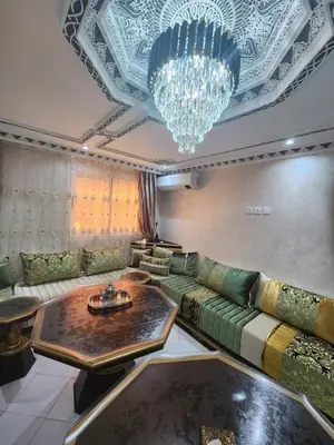 a living room with a couch and a chandelier at 2 bedroom apartment, living room, kitchen in Marrakech in Marrakech