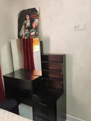 a black desk with a painting on the wall at 2 bedroom apartment, living room, kitchen in Marrakech in Marrakech