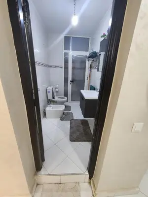a bathroom with a toilet and a sink and a mirror at 2 bedroom apartment, living room, kitchen in Marrakech in Marrakech