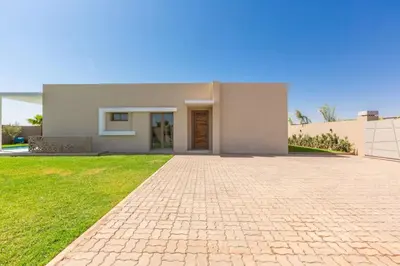 a house with a brick driveway in front of it at Villa Seyana 1 Zero Vis a Vis et Piscine Chauffee in Marrakech