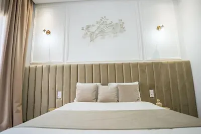 a bedroom with a large bed with a wooden headboard at Villa Seyana 2 Zero vis a vis, Piscine Chauffee in Marrakech