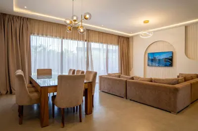 a living room with a dining table and a couch at Villa Seyana 5 Zero vis a vis Piscine chauffee in Marrakech