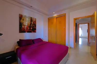 a bedroom with a large purple bed in it at DannaMs Apartment MohamedV Hivernage in Marrakech