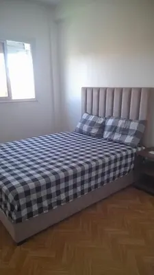 a bedroom with a bed with a checkered blanket at Bahiya in Marrakech