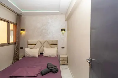 a bedroom with a bed with a bow tie on it at Superbe Appart 3 pièces Moderne, Confort avec vue panoramique sur Marrakech plein centre à 7 min a pied de Gueliz in Marrakech