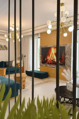 a living room with a fire in a fireplace at cozy villa 3 Rooms pool wifi -Only Family in Marrakech