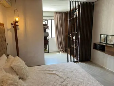 a bedroom with a white bed with a black gate at cozy villa 3 Rooms pool wifi -Only Family in Marrakech