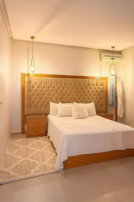 a bedroom with a large bed with a large headboard at cozy villa 3 Rooms pool wifi -Only Family in Marrakech
