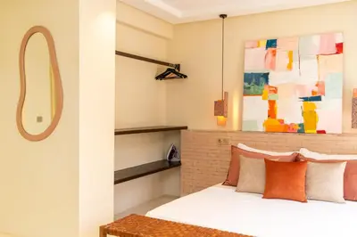 a bedroom with a bed with orange pillows at fantastic Apartment in Marrakech