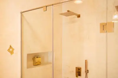a shower with a glass door in a bathroom at fantastic Apartment in Marrakech