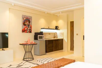 a living room with a kitchen and a table at fantastic Apartment in Marrakech