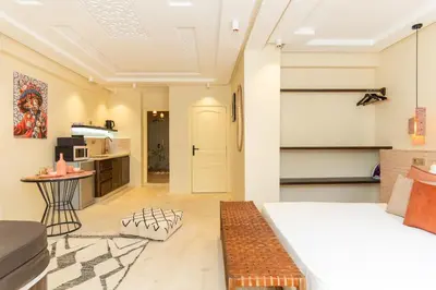a living room with a bed and a kitchen at fantastic Apartment in Marrakech
