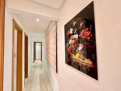 a hallway with a large painting on the wall at Modern and Central Apartment with Terrace and Free Parking in Marrakech