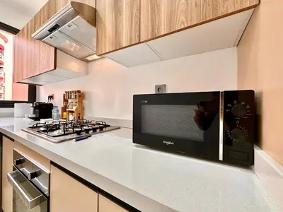a kitchen with a microwave oven on a counter at Modern and Central Apartment with Terrace and Free Parking in Marrakech