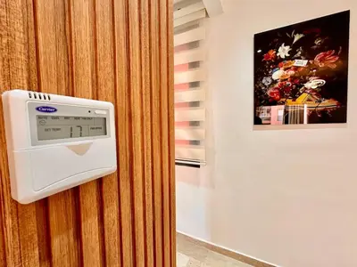 a wall mounted thermostat on a wall with a picture at Modern and Central Apartment with Terrace and Free Parking in Marrakech