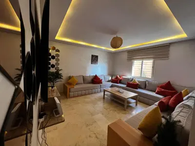 a living room with a couch and a table at Cozy & Elegant apartment Marrakech in Marrakech