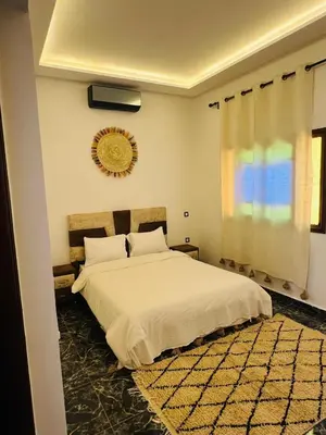 a bedroom with a large white bed and a window at Excellente Villa A Proximité De Marrakech in El Aïn
