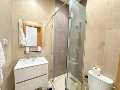 a bathroom with a sink and a glass shower at elegance apartment in Marrakech in Marrakech