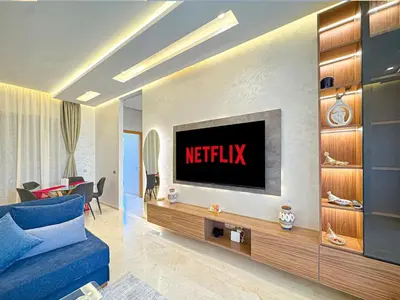 a living room with a television on a wall at elegance apartment in Marrakech in Marrakech
