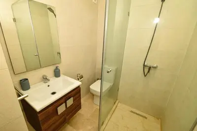 a bathroom with a shower and a sink and a toilet at Superbe T3 neuf - Proche centre - Piscines et Clim - Marrakeck in Marrakech