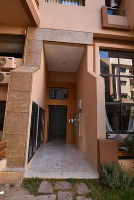 a building with a hallway leading to a door at Superbe T3 neuf - Proche centre - Piscines et Clim - Marrakeck in Marrakech