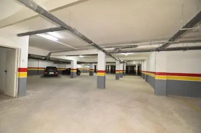 an empty parking garage with cars parked in it at Superbe T3 neuf - Proche centre - Piscines et Clim - Marrakeck in Marrakech