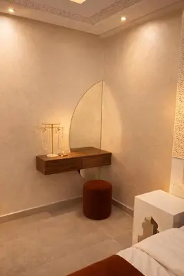 a room with a table and a bed and a bed at Appartement spacieux centre ville quartier dynamique in Marrakech
